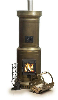Venice 20 DIY masonry heater kit in bronze finish, showing glass firebox door with active fire, matching curved log holder, and fireplace tools